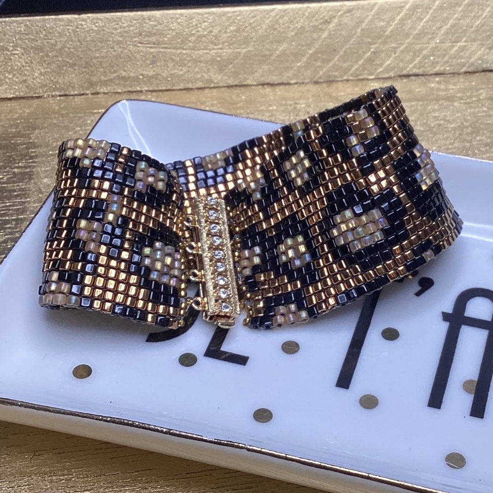 Hand beaded peyote style bracelet. Leopard print, bronze and black bracelet